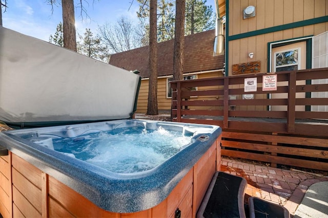 view of pool with a hot tub