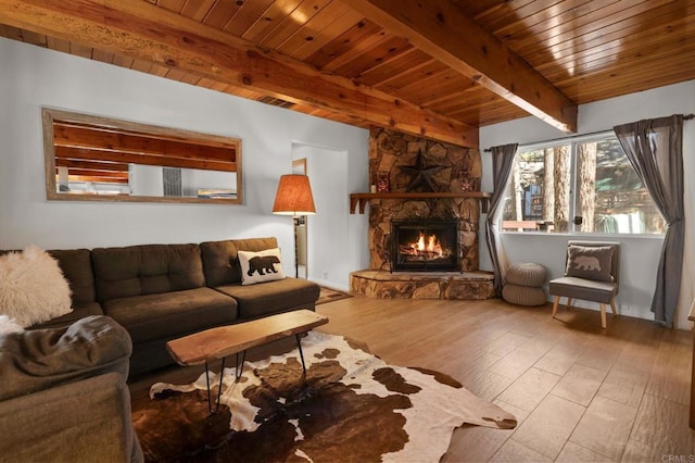 living room with a fireplace, light hardwood / wood-style floors, and beam ceiling