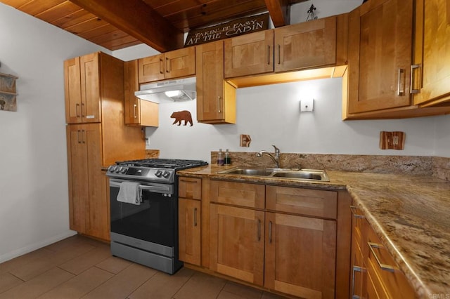 kitchen with sink, wood ceiling, stainless steel gas range, light stone countertops, and beamed ceiling