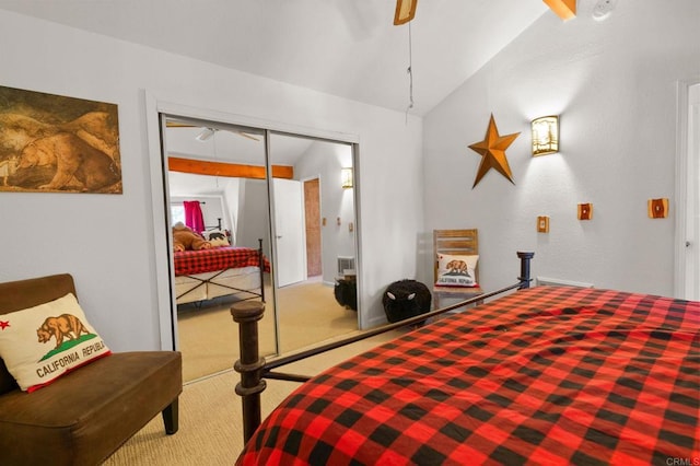 carpeted bedroom with vaulted ceiling and a closet