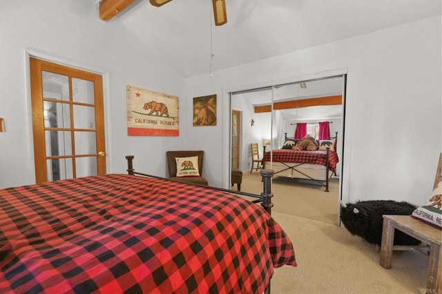 carpeted bedroom with lofted ceiling with beams, ceiling fan, and a closet