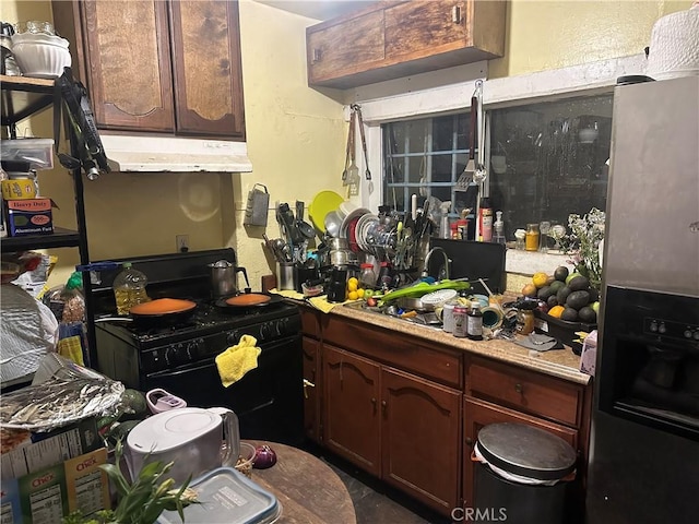 kitchen with dark brown cabinets and black gas range