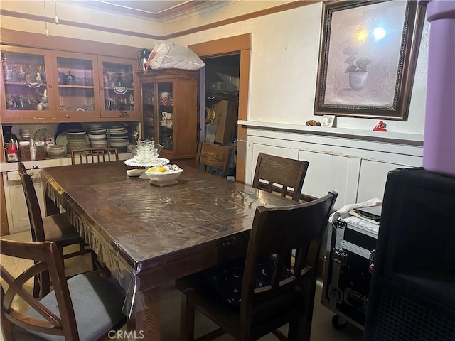 dining space featuring crown molding