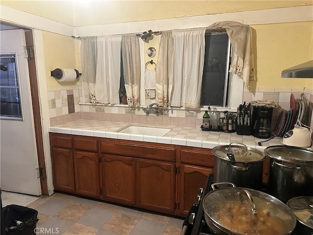 bathroom with sink and tasteful backsplash