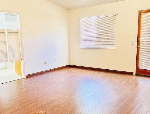 empty room with light hardwood / wood-style flooring