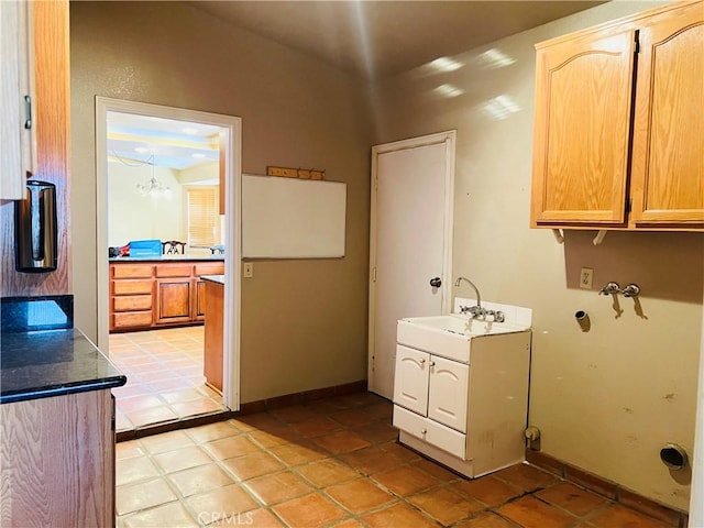 laundry area featuring light tile patterned flooring, hookup for a washing machine, and sink