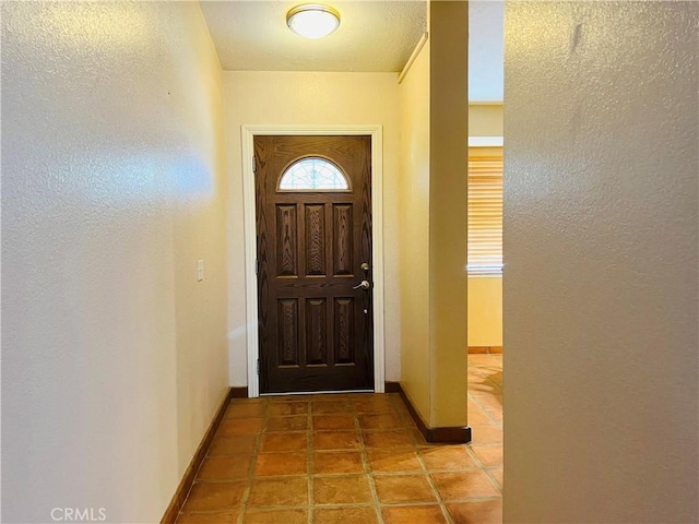 doorway with light tile patterned floors