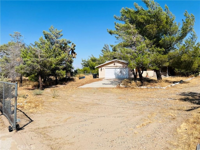 obstructed view of property with a garage