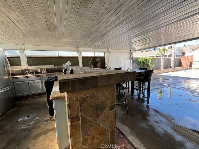 view of patio / terrace featuring an outdoor bar