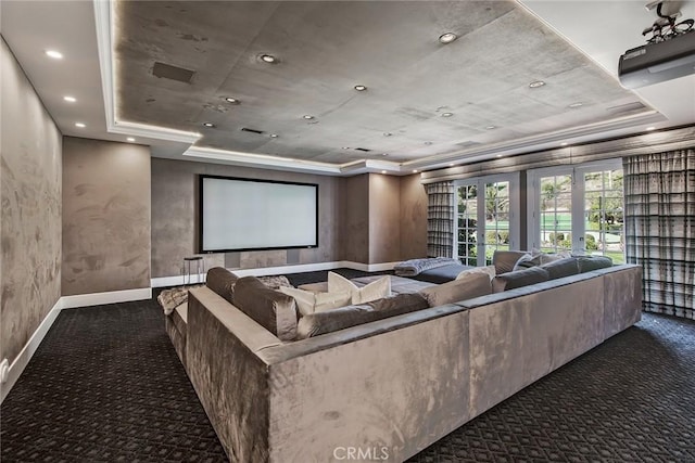 carpeted home theater room featuring a raised ceiling and french doors