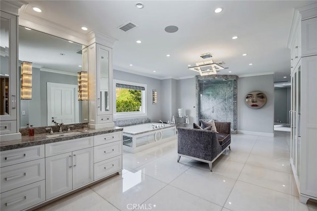 bathroom featuring a tub, vanity, crown molding, and tile patterned flooring