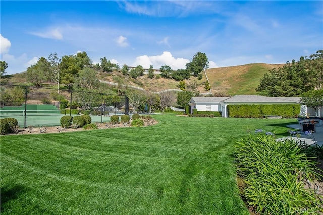 view of yard featuring tennis court