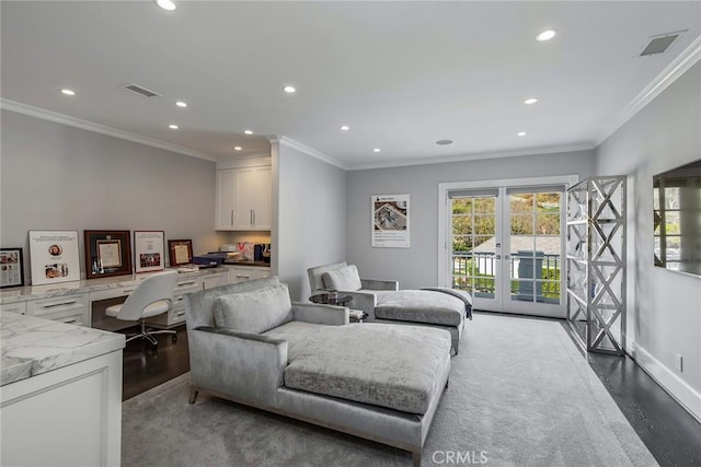 living room with built in desk, french doors, crown molding, and hardwood / wood-style flooring