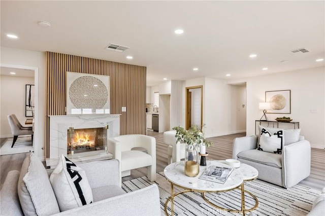 living room featuring light hardwood / wood-style floors and a premium fireplace