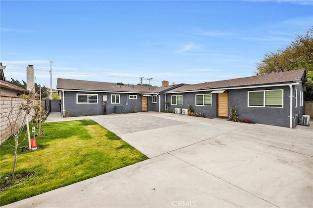 single story home with a front lawn and central AC