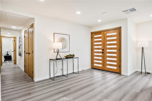 foyer entrance with light hardwood / wood-style floors