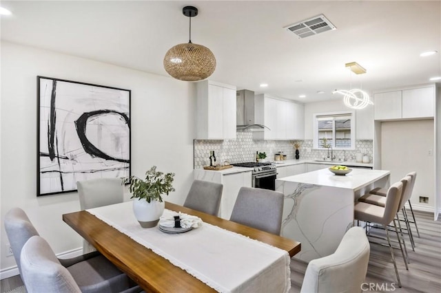 dining area featuring wood-type flooring and sink