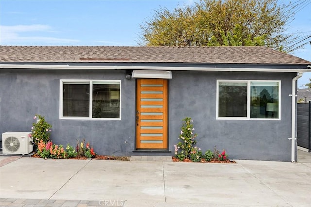 doorway to property featuring ac unit and a patio