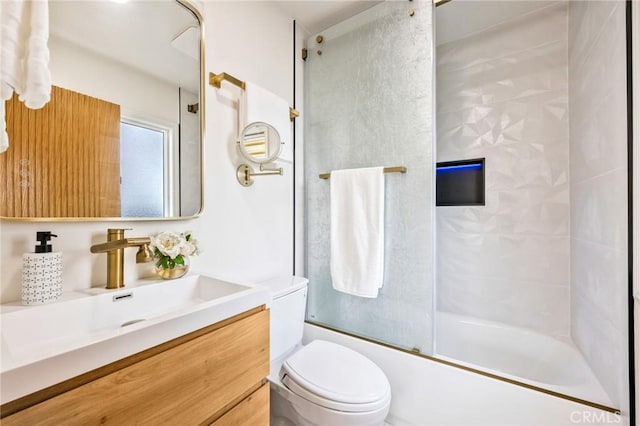 full bathroom with toilet, bath / shower combo with glass door, and vanity