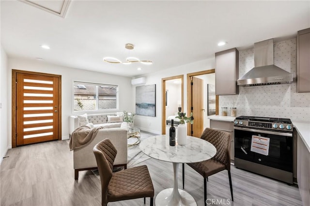 dining room featuring light hardwood / wood-style floors and a wall mounted AC