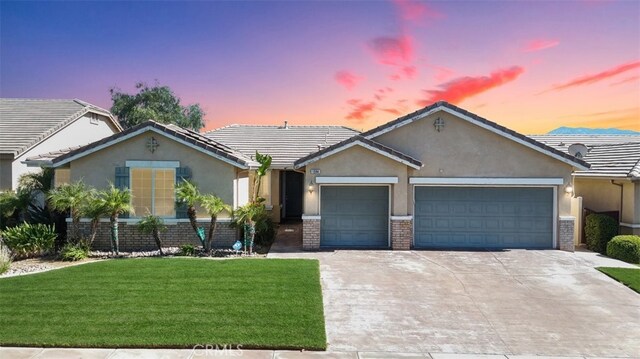 ranch-style home with a yard and a garage