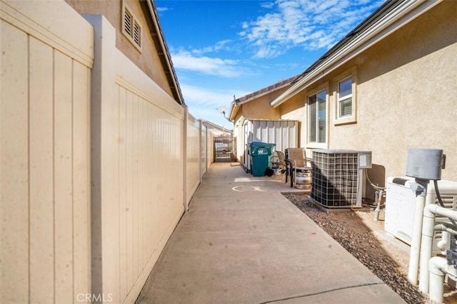 view of home's exterior featuring cooling unit and a patio