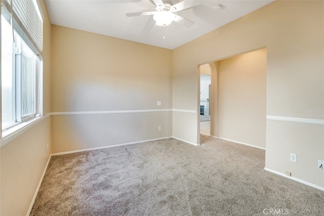 carpeted spare room with ceiling fan