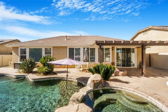 back of property with a pergola and a patio area