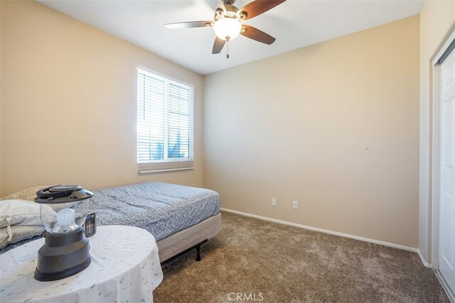 bedroom with ceiling fan and carpet