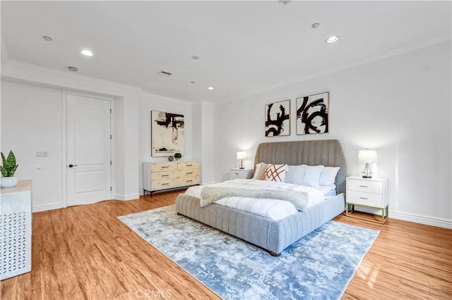 bedroom featuring ornamental molding and hardwood / wood-style flooring