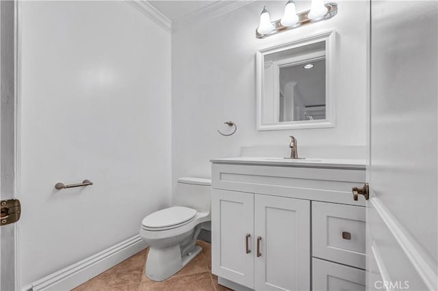 bathroom featuring toilet, vanity, ornamental molding, and tile patterned flooring