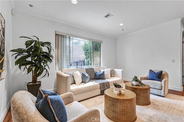 living room with crown molding and light hardwood / wood-style flooring