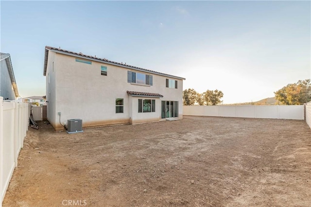 rear view of property with central air condition unit