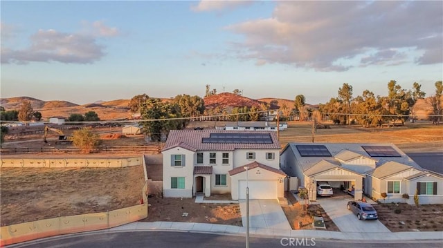 view of front of property with a garage and a mountain view