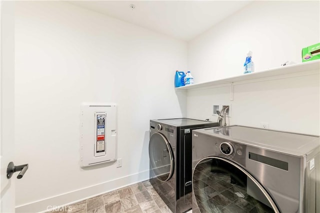 clothes washing area with washer and clothes dryer