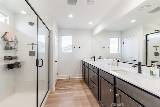 bathroom with vanity, hardwood / wood-style flooring, and walk in shower