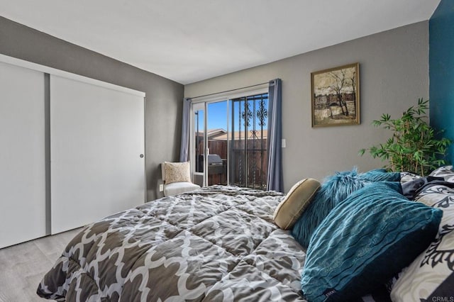 bedroom with a closet and light hardwood / wood-style flooring