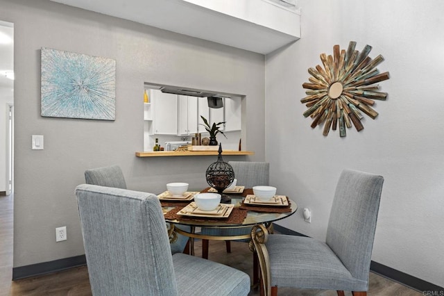 dining area with dark hardwood / wood-style floors