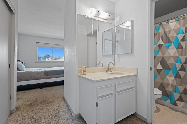 bathroom with toilet and vanity