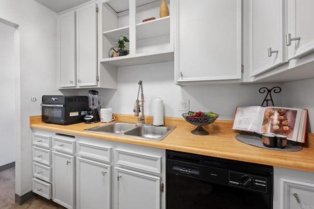 kitchen featuring dishwasher, white cabinets, and sink