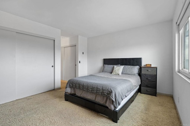 bedroom featuring light colored carpet