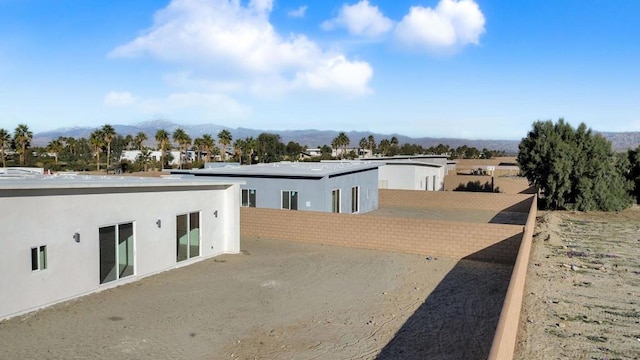 exterior space with a mountain view and a patio