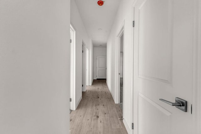 corridor with light hardwood / wood-style flooring