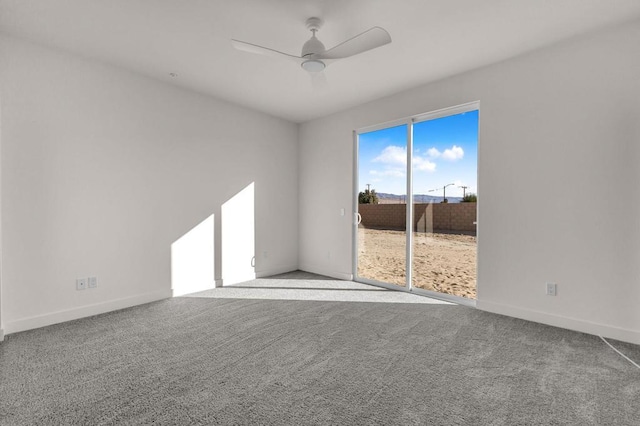 spare room featuring ceiling fan and carpet flooring