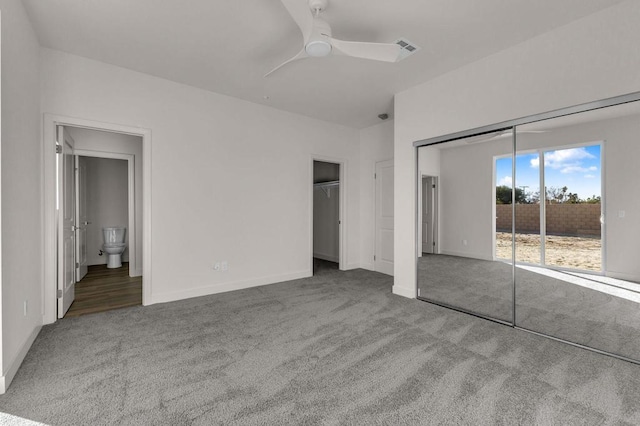 unfurnished bedroom featuring ensuite bathroom, ceiling fan, and carpet flooring