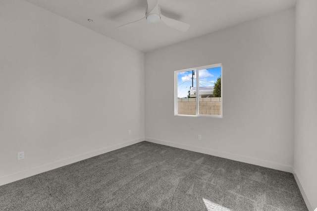 spare room with ceiling fan and carpet