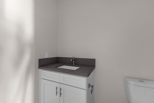 bathroom with toilet and vanity