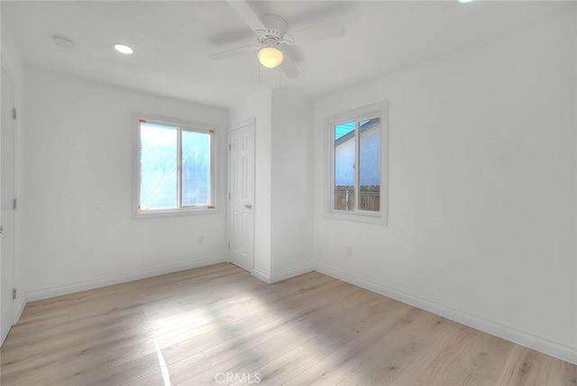 spare room featuring ceiling fan and light hardwood / wood-style floors