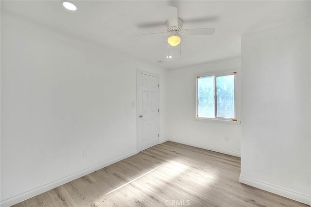 empty room featuring ceiling fan and light hardwood / wood-style floors