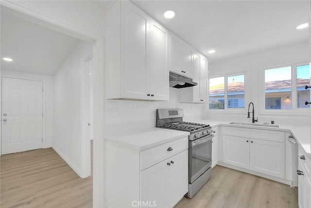 kitchen featuring white cabinets, light wood-type flooring, sink, and stainless steel range with gas stovetop